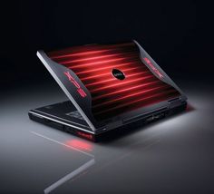 the laptop is lit up with red light coming from it's back cover and keyboard