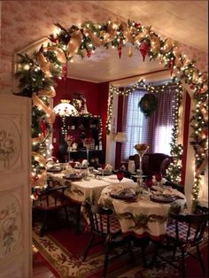 a dining room decorated for christmas with lights