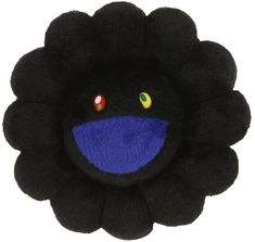 a black flower with blue and yellow eyes on it's center, in front of a white background