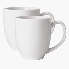 two white coffee mugs sitting next to each other