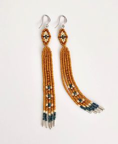 the beaded earrings are hanging from silver hooks