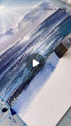 an image of watercolors being used to paint the ocean with blue and white colors