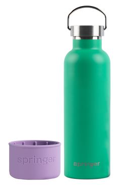 a green water bottle next to a purple cup