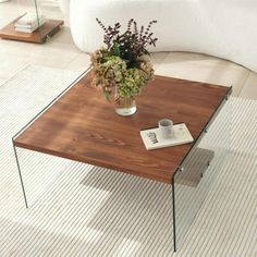 a coffee table sitting on top of a white rug