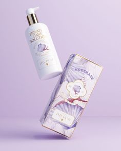 a bottle of lotion next to a box on a purple and white background with the lid open