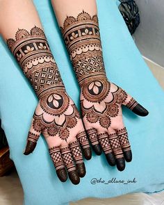 two hands with henna designs on them