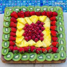 a square shaped fruit platter with kiwis, strawberries and bananas