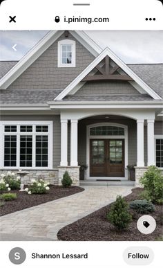 a house with gray siding and white trim