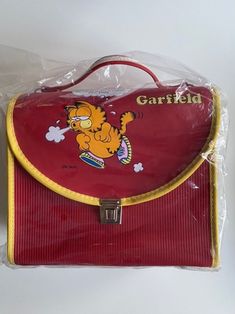 VINTAGE GARFIELD SCHOOLBAG - SHOULDER BAG - HANDBAG Shoulder belt included. From the 80s Rare item New old stock Color: red In its original packaging Fast and reliable shipping in sturdy cardboard boxes. FREE SHIPPING to Europe and the United States.  Additional cost for Track and Trace Please ask any questions prior to ordering and make sure you check all photo's. Note that this is a vintage item and it may have slight imperfections. Item sold as is. Don't forget to check out our other listings and feel free to message us! Retro School Shoulder Bag, Vintage Rectangular School Bags, Retro Red School Shoulder Bag, Vintage School Satchel Bag, Vintage Satchel Shoulder Bag For School, Vintage Shoulder Bag Satchel For School, Vintage Shoulder Satchel For School, Vintage Garfield, Jim Davis