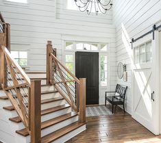 an open living room with stairs leading up to the kitchen