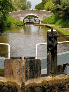 the gate is open to allow people to go on a boat in the river or canal