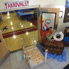 an indoor basketball court is decorated with wooden planks and other decorations, including a pirate's chest