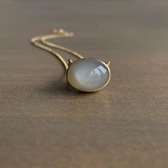 Mimi Favre Gray Moonstone Necklace – Meeka Fine Jewelry Delicate Moonstone Necklace In Yellow Gold, Yellow Gold Oval Necklace With Moon Charm, Oval Moonstone Necklace In Yellow Gold, Yellow Gold Moonstone Necklace With Round Pendant, Yellow Gold Moonstone Pendant Necklace, Elegant Moonstone Necklace With Large Stone, Oval Moonstone Necklaces With Moon Charm, Gold Polished Moonstone Jewelry, Gold Moonstone Jewelry With Polished Finish