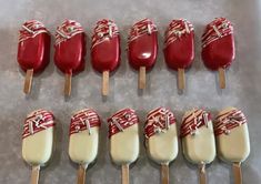 red and white candy pops are lined up on a table