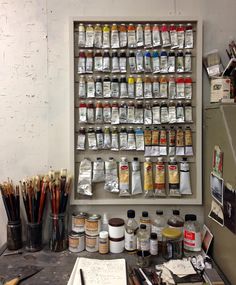 a wall mounted spice rack filled with lots of spices