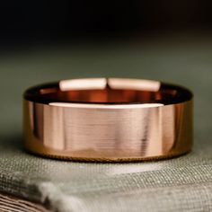 a gold ring sitting on top of a piece of cloth