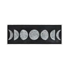 four phases of the moon on a black and white background, framed in a wooden frame