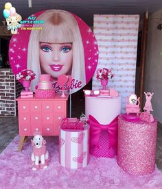 there is a barbie party set up with pink decorations and accessories on the table in front of it