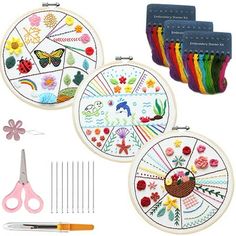 three embroidery kits with scissors and thread