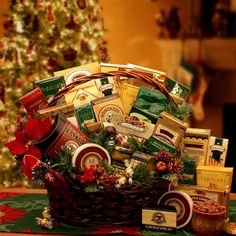 a basket filled with lots of food next to a christmas tree