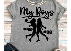 a t - shirt with the words my boys on it and two girls playing basketball