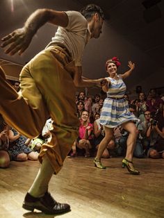 two people are dancing in front of an audience