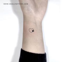 a small heart tattoo on the wrist is shown in black and white, as well as an arrow