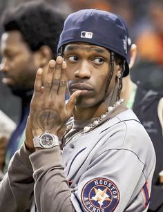 a close up of a baseball player holding his hand in the air with one hand