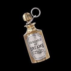 an old fashioned bottle keychain with the words esserce of dreams on it