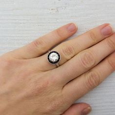 a person's hand with a ring on it