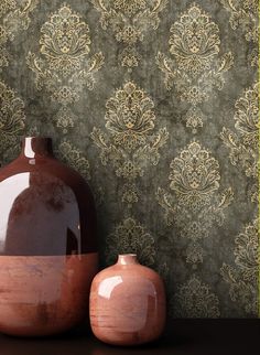 two vases sitting next to each other in front of a wallpapered background