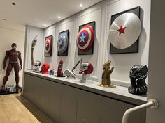 a display case filled with captain america masks and figurines on top of shelves