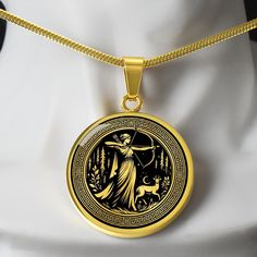 a gold necklace with an image of a woman holding a bow and arrow on it