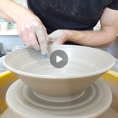 a man making a bowl out of clay on top of a pottery wheel with his hands