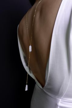 This simple and dainty back drop necklace features two freshwater biwa pearls and looks great with backless tops and dresses. There is no clasp, it is completely reversible, so you can wear it in the front over a sweater or tee. So lightweight - you won't even know it's on! "BIWA FRESHWATER PEARL BACK DROP NECKLACE" by GoldenLinings - Christine Elizabeth Jewelry D E T A I L S Materials: 14K Gold Fill or Sterling Silver S I Z E S Measures 26" (so you can put it over your head) Drop measures: approx 4" M A T E R I A L S With so many terms to describe gold jewelry, it can be confusing to know exactly what you're buying and how to care for it. Gold fill contains 100+ times more real gold than gold-plated jewelry. It is heat bonded, making it more durable than gold-plated jewelry. It's a great Christine Elizabeth Jewelry, Elegant Pearl Backdrop Necklace With Delicate Chain, Delicate White Backdrop Necklace For Party, Minimalist White Lariat Pearl Necklace, Minimalist Pearl Drop Backdrop Necklace, Elegant White Pearl Chain Backdrop Necklace, Elegant White Backdrop Necklace With Pearl Chain, Elegant White Backdrop Necklace With Pearl Pendant, Delicate Long Drop Backdrop Necklace For Formal Occasions