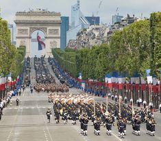 a group of people in uniform marching down the street