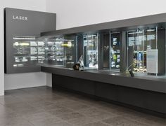 a display case with several items on it in a room that is white and grey