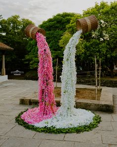 two vases with flowers on them are in the middle of a flowerbedd area