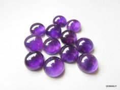 purple glass marbles on a white surface with space for the word's logo