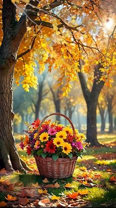 a basket full of flowers sitting under a tree