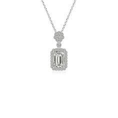 The Emerald Cut Daimond is claw-set and linked to a floral bale by a bezel-set station diamond. A scalloped halo of dazzling round diamonds illuminates the octagonal sparkling gemstone. Finished with milgrain edges and elaborate cutwork on the back, this exquisite silver pendant exudes an old world charm. Platinum Pendant, Emerald Cut Diamond, Old World Charm, Emerald Cut Diamonds, Cut Work, Bezel Setting, Emerald Cut, Diamond Pendant, White Diamond