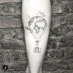 a tattoo on the leg of a person with a hot air balloon flying over it