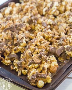 a tray filled with chocolate covered popcorn on top of a table