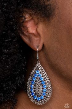 Set against an airy, dot motif backdrop, faceted blue rhinestones curve into a teardrop shape atop an oversized silver teardrop lure, creating a dazzling pop of color near the ear. Earring attaches to a standard fishhook fitting.

 Sold as one pair of earrings. Sparkly Accessories, Blue Dangle Earrings, Blue Accessories, Paparazzi Accessories, Timeless Accessories, Paparazzi Jewelry, Pink Earrings, Blue Rhinestones, Blue Earrings