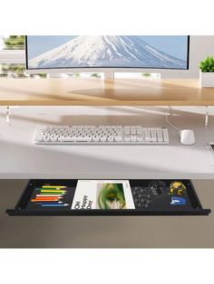 a desk with a keyboard, mouse and monitor on it