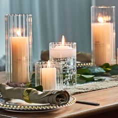 candles are lit on a wooden table