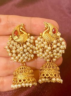 These exquisite Antique Peacock Earrings come in 4 beautiful colors and are perfect for adding a touch of elegance to any Indian outfit. Crafted with intricate antique detailing, these earrings are a must-have for any fashion-forward individual. Elevate your style with these stunning pieces. Length - 5cm Jewellery Care- Keep the jewelry dry, avoid heat and contact with perfumes & water. Ornate Peacock Design Earrings For Celebration, Elegant Peacock Design Dangle Earrings, Festive Peacock Design Jhumkas, Elegant Dangle Earrings With Peacock Design, Elegant Gold Earrings With Peacock Design, Festive Jhumkas With Peacock Design, Ornate Peacock Chandbali Earrings, Temple Jewelry Peacock Design Drop Earrings, Elegant Peacock Design Chandelier Earrings