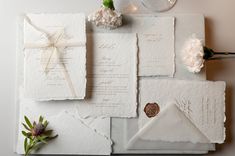 the wedding stationery is laid out on top of each other