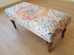 a bench sitting on top of a hard wood floor