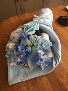 a blue towel with flowers on it sitting on a table